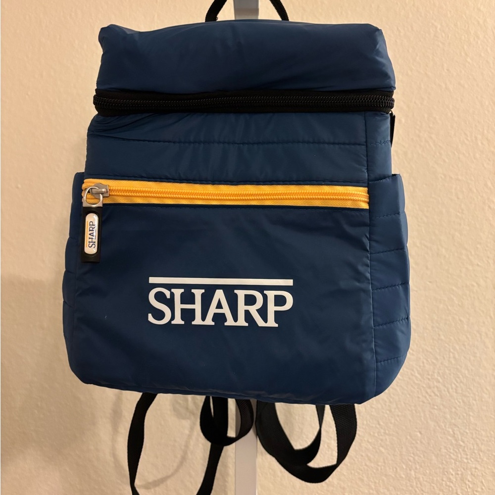 Blue Backpack with Yellow Accent. Brand new with pockets on the sides